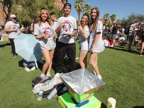 (From left) First-year students Grace Cornelius, Karam Alshammari, Danniella Martinez and Cameryn Black from Team Animal Crackers use recyclable materials to cook biscuits at the University of Arizona Mall.