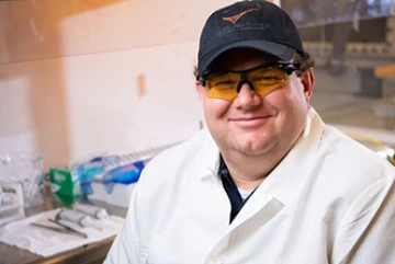 man wearing glasses and baseball hat