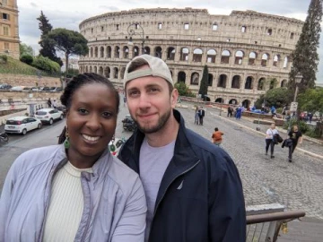 woman and man in front of collesium, rome