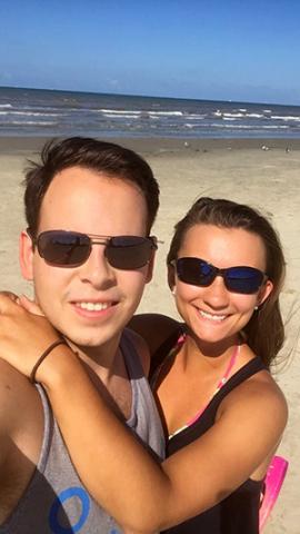 A smiling couple on a sandy beach