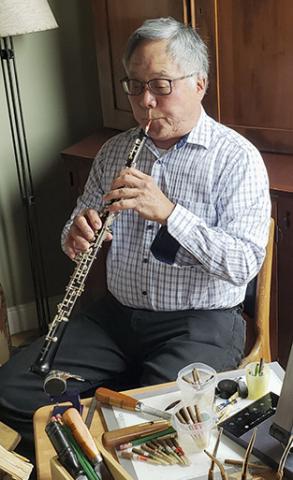 man playing an oboe