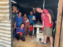 Kelly Stark and her family with a Guatamalan family in their home.