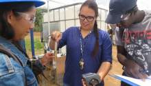 UArizona graduate student Marisa Gonzalez, an Indigenous Food, Energy and Water Security and Sovereignty (Indige-FEWSS) trainee, takes a conductivity measurement with Diné College students in Tsaile, Arizona