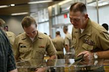 Professor of naval science and Colonel Patrick Wall, converses with ROTC member Alexander Heydt on Wednesday, Aug. 31. UA's special collections gave UA NROTC a special tour of the USS Arizona exhibit. Photo by Jesus Barrera/The Daily Wildcat