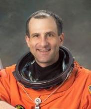 A man in an orange space suit