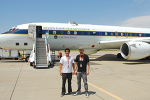 Researchers outside airplane