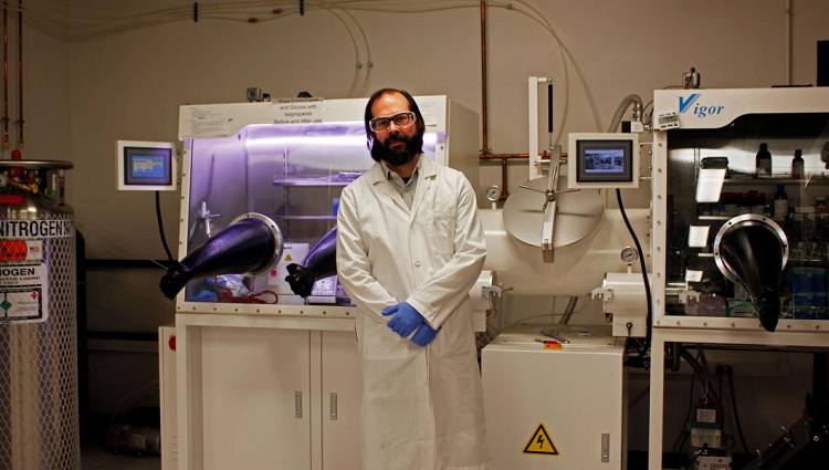 Engineering professor Adam Printz standing in front of a biosafety cabinet
