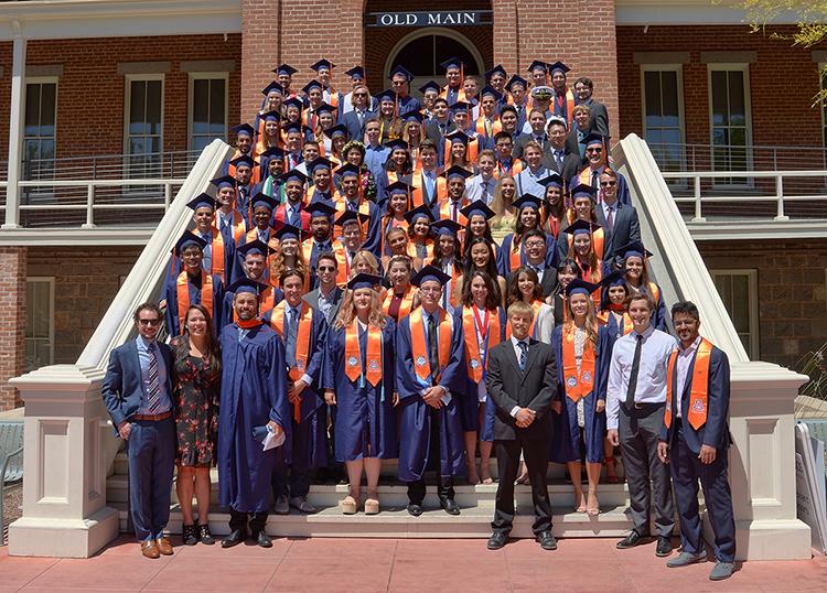 CHEE Class of 2019 on the steps of Old Main in caps and gowns