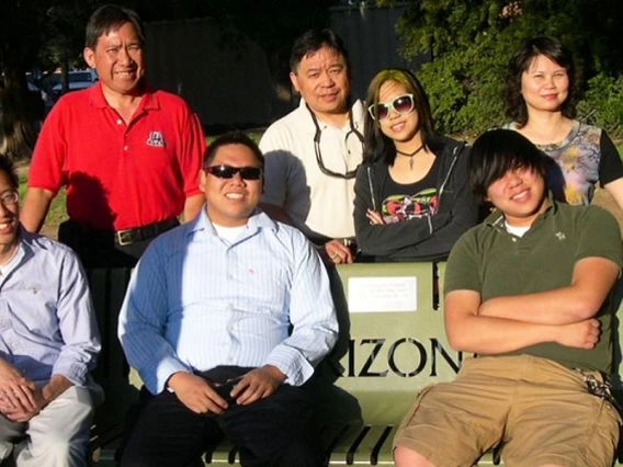 The Hom family visits the memorial bench honoring Hom Moon Jung.