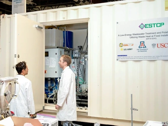 Associate professor of chemical and environmental engineering at the Unversity of Arizona College of Engineering Andrea Achilli (left) and Luke Presson (right) evaluate the ESTCP Demonstration Project semi-portable, containerized advanced water purification unit.