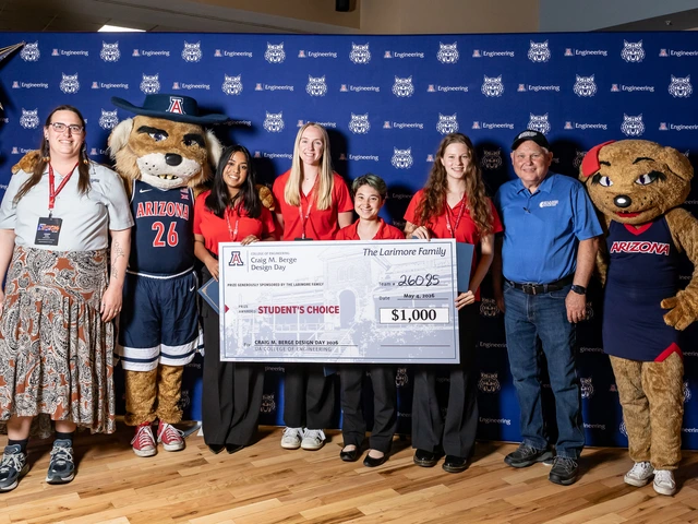 A mixed group of people hold a large check.