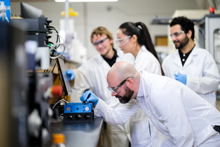people on a laboratory, wearing goggles
